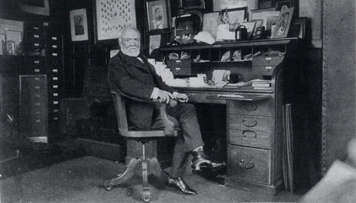 Historic photo of Andrew Carnegie at desk